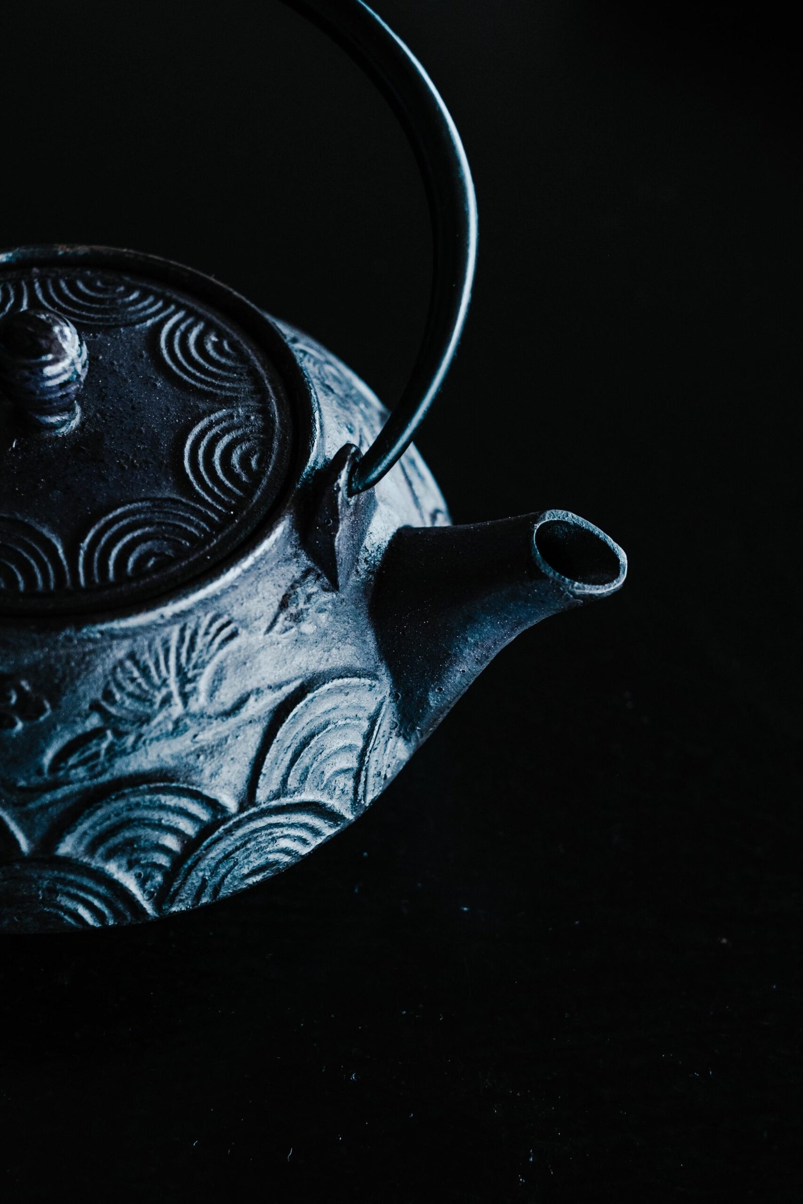 Detailed shot of a decorative ceramic teapot with intricate patterns. Elegant and artistic composition.